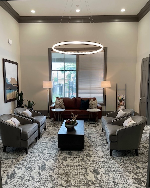 a living room filled with furniture and a large window