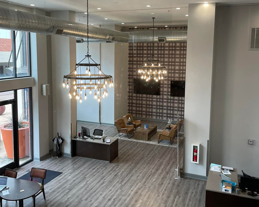 a living room filled with furniture and a large window