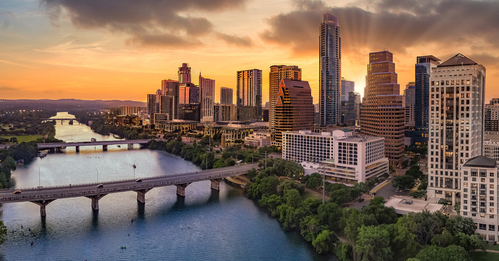 a bridge over a body of water with a city in the background