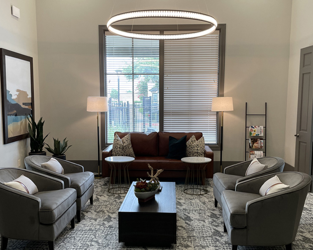a living room filled with furniture and a large window